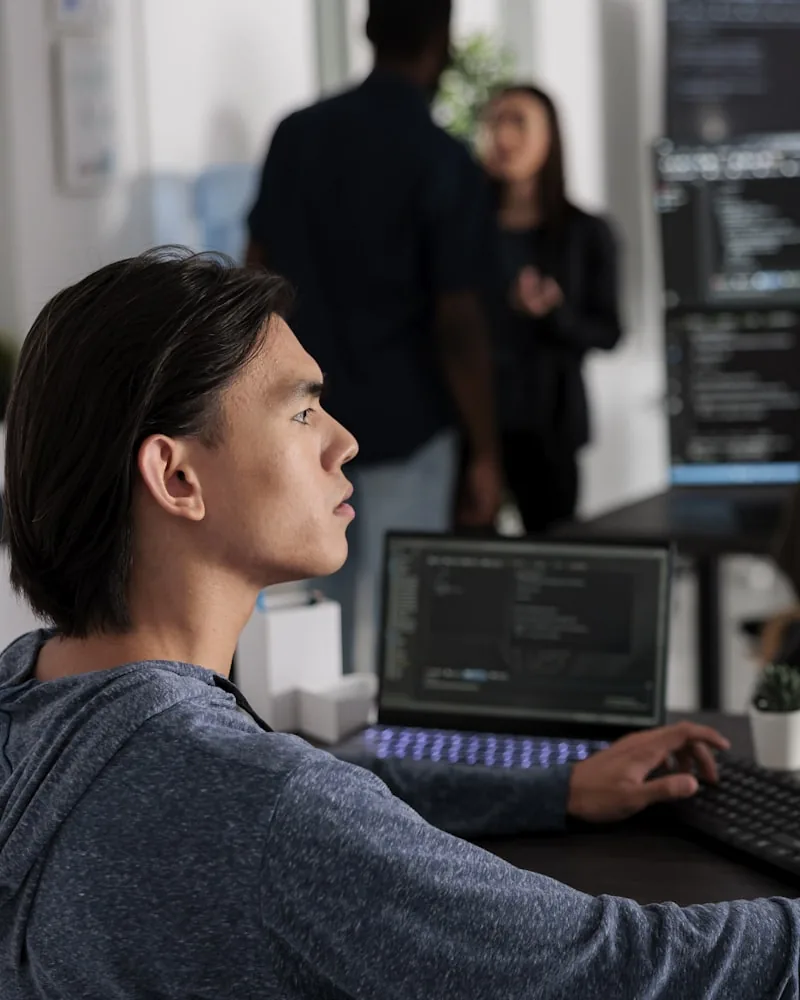 A developer working across two monitors
